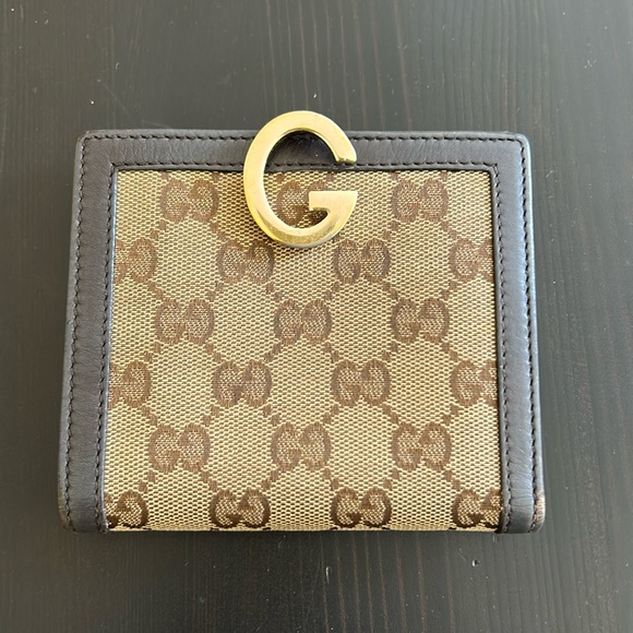 Gucci Accessories - Gucci G clip leather and canvas mid sized bifold wallet